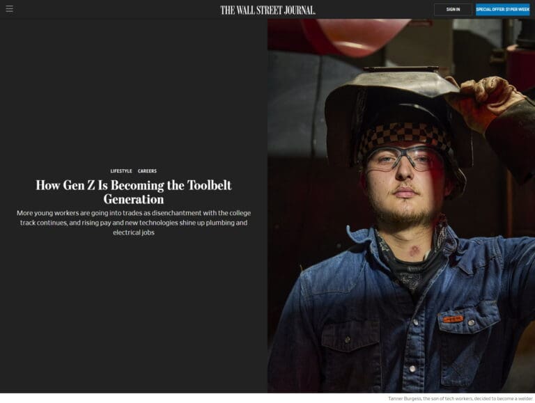 A young worker in a workshop wears a hard hat and safety glasses with a welding mask lifted, embodying the 'toolbelt generation.' Text headline: "How Gen Z Is Embracing Skilled Trades.